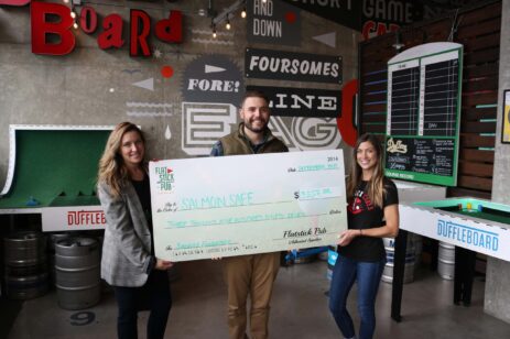 Representatives from a nonprofit receiving a donation check.