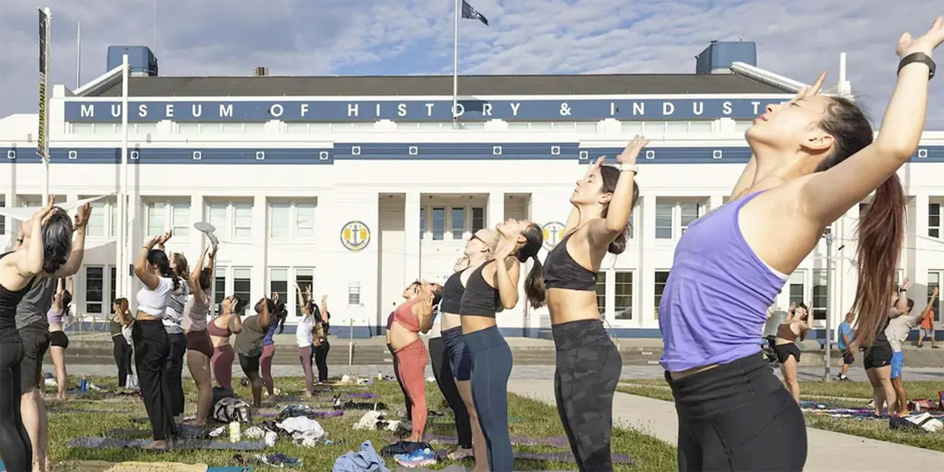 people doing yoga in the park