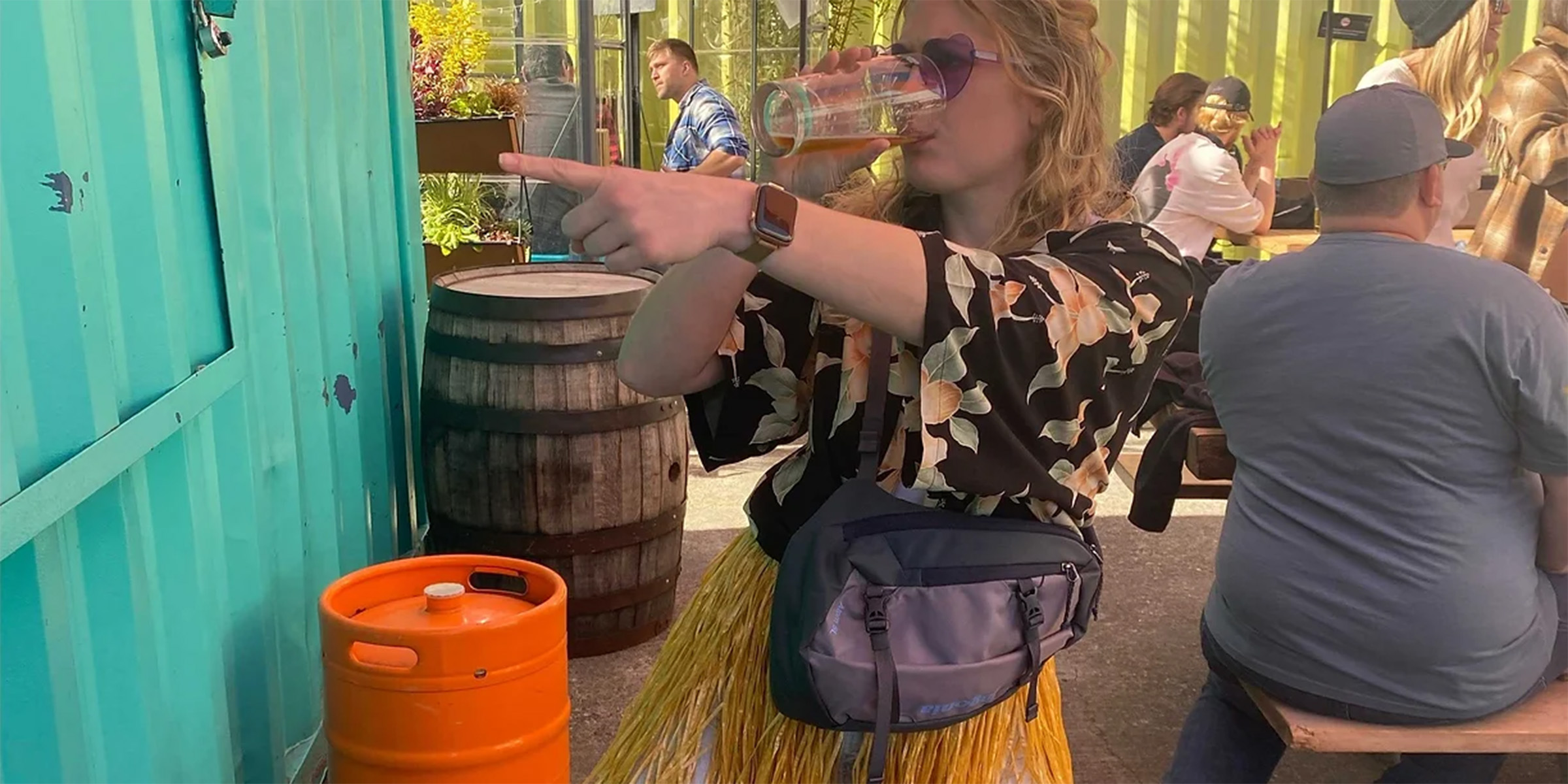 Woman drinking a beer and pointing