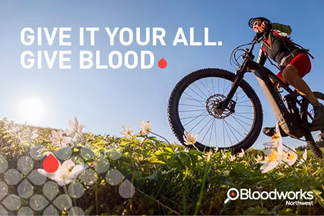 person riding bike with slogan
