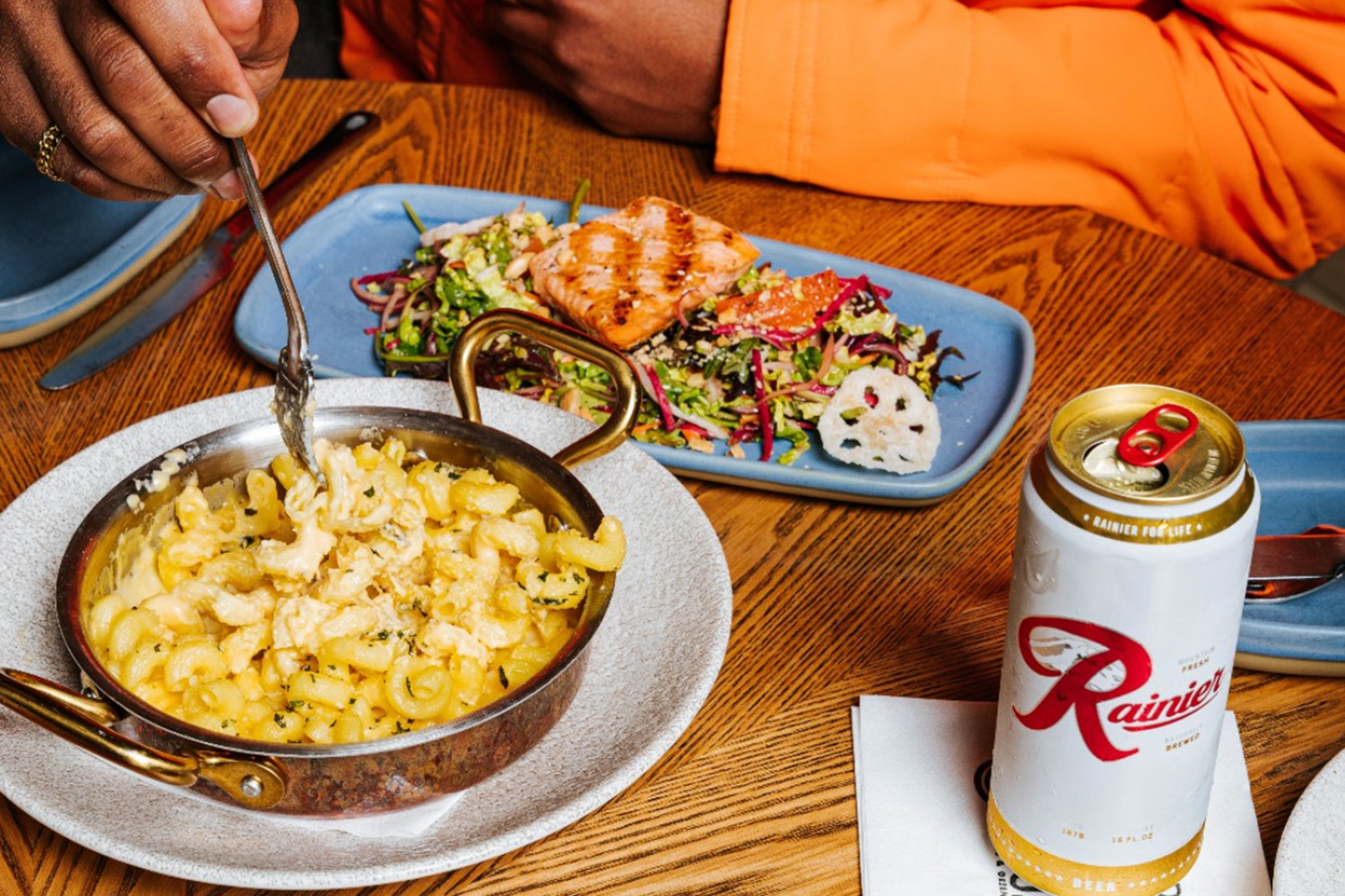 someone eating a meal and drinking beer