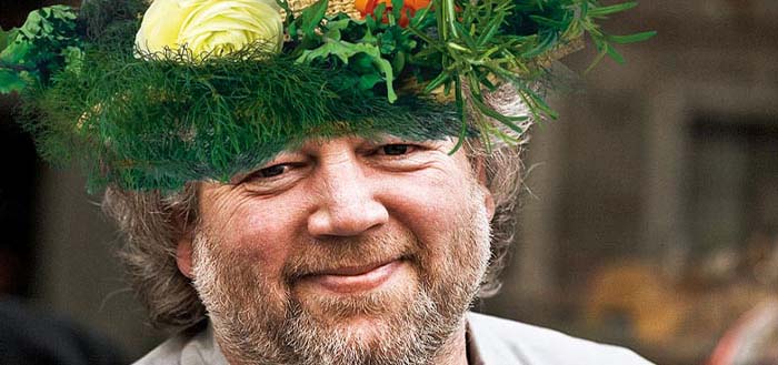 Chef Tom Douglas wearing a vegetable straw hat.