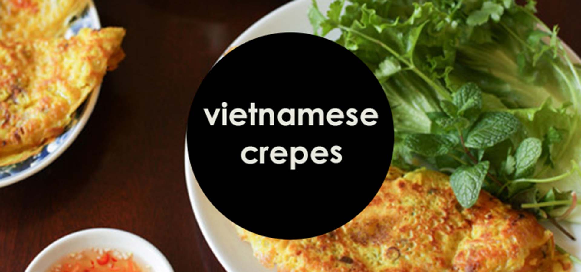 Table with plated Vietnamese crepes.