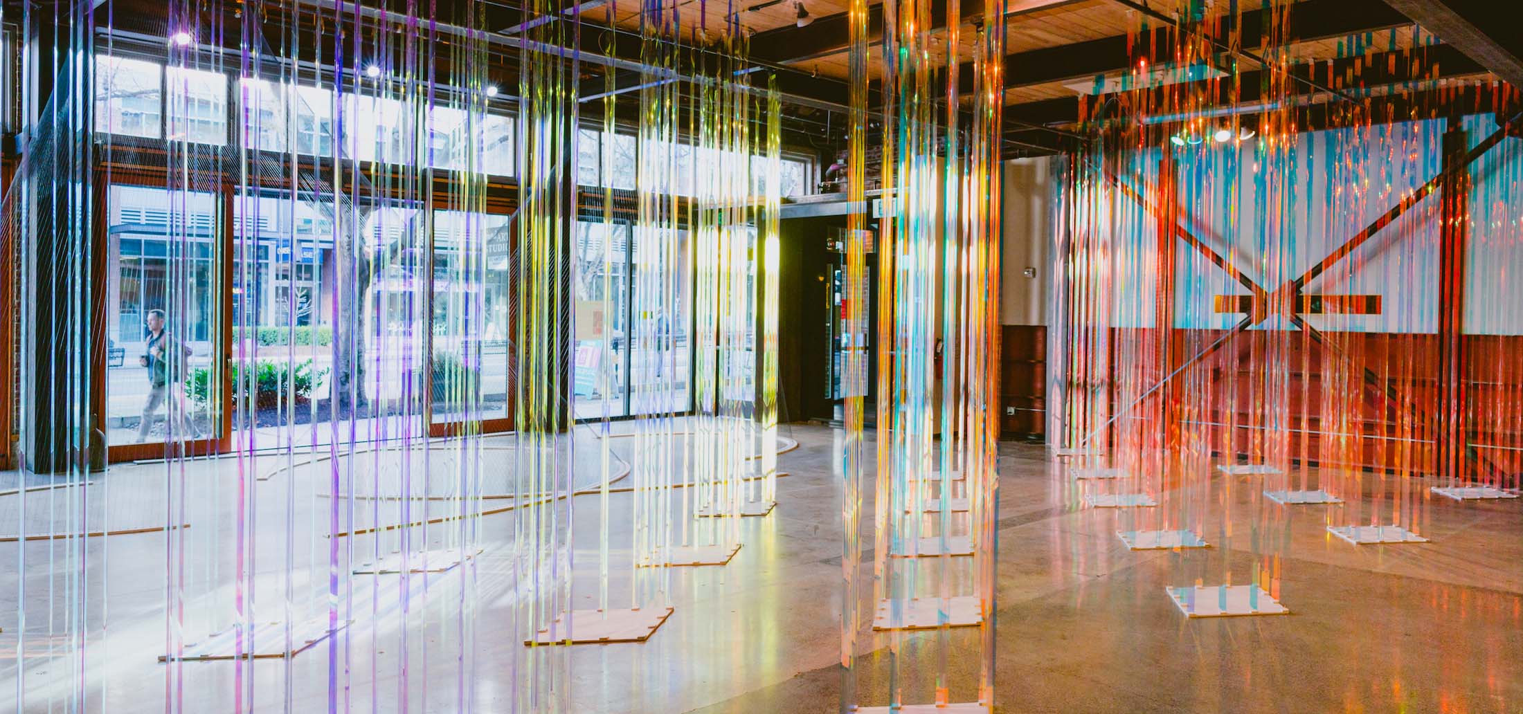 Colorful art installation of acrylic pillars to wander through.