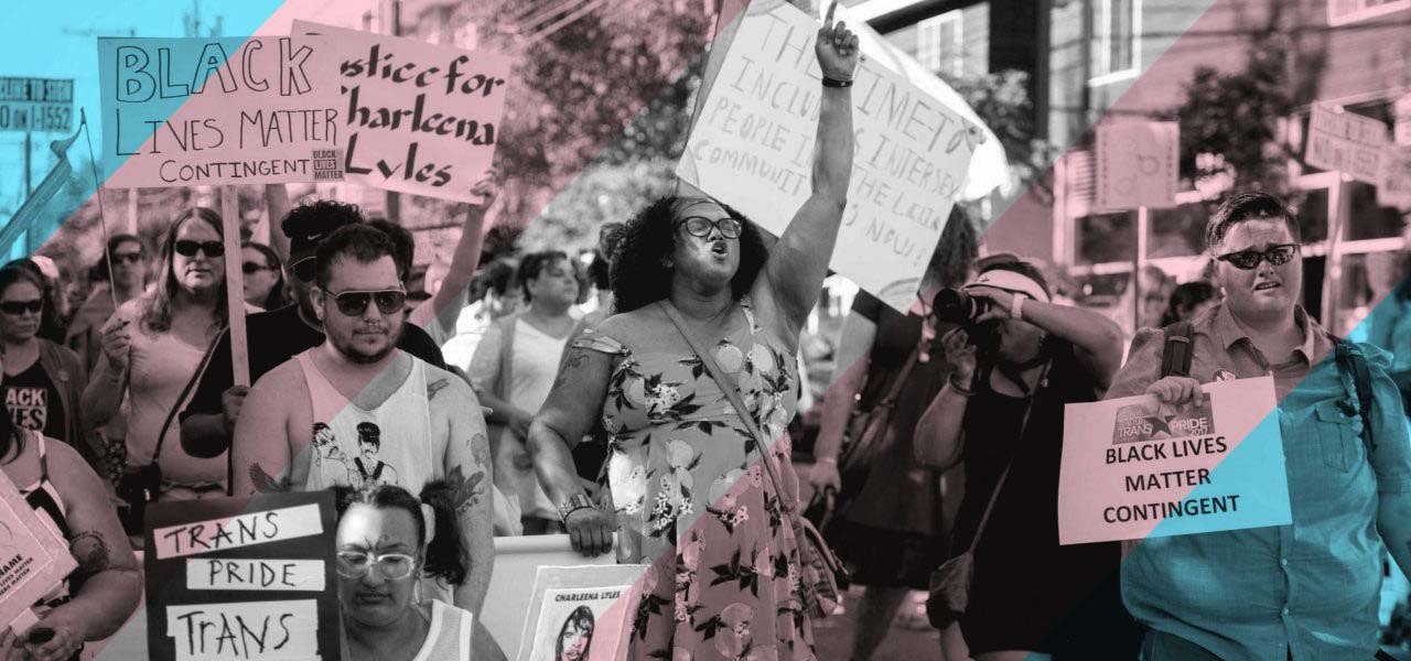 Protesters marching and holding signs for workers rights.