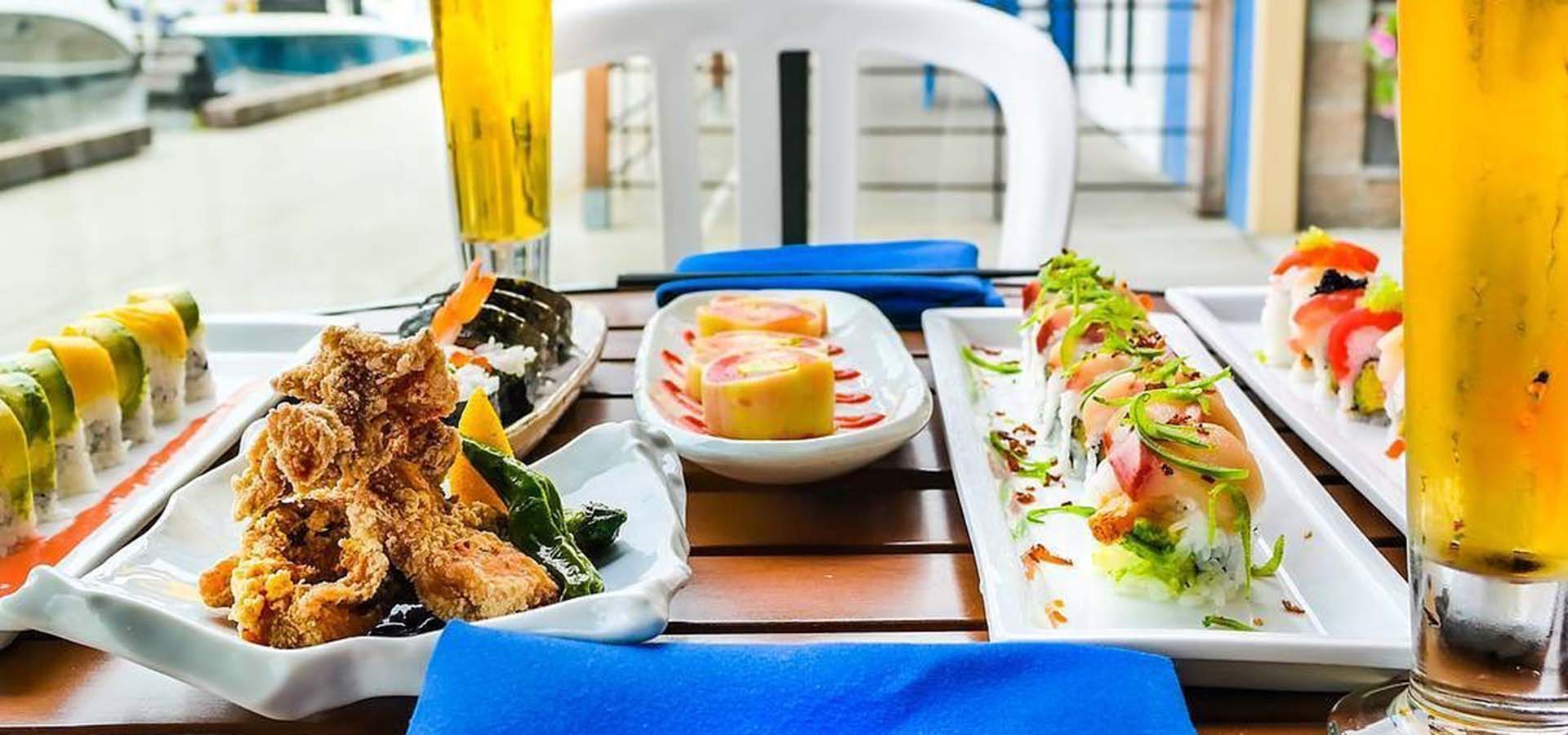 A sushi meal for two set up on a patio dining table.