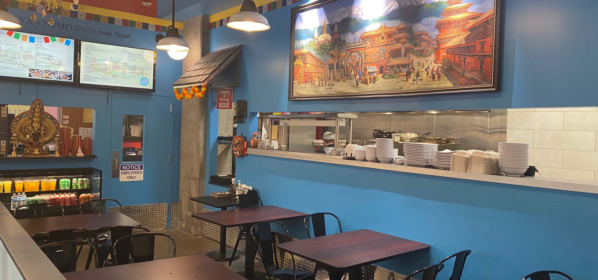 Inside of a Nepalese restaurant with blue walls.