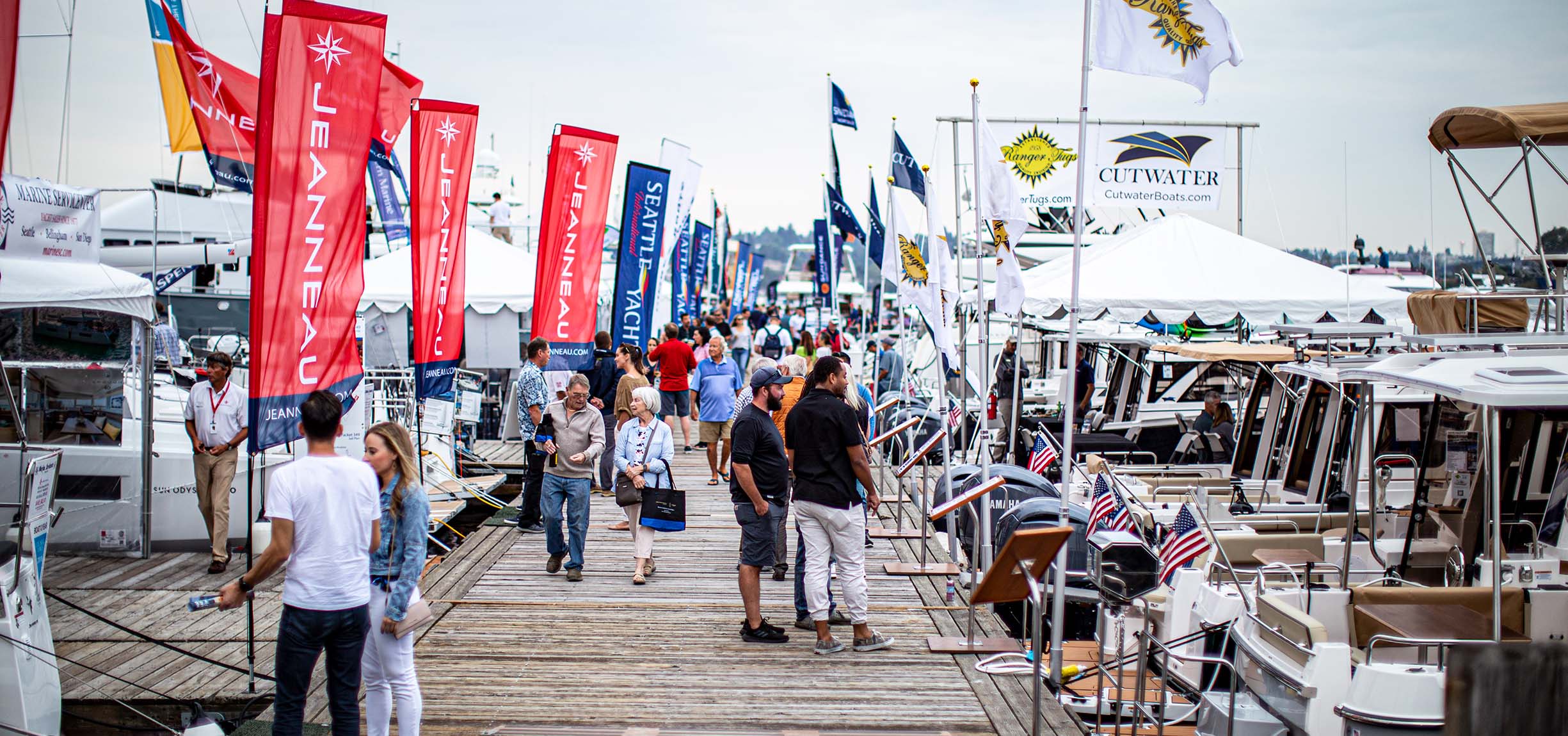 People looking at float craft on a dock.