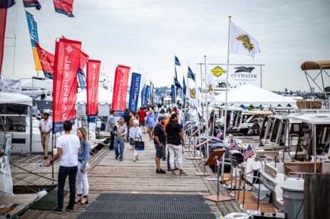 People looking a yachts during a boat show.