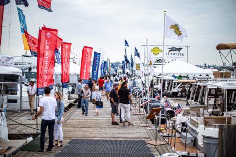 People looking at float craft on a dock.