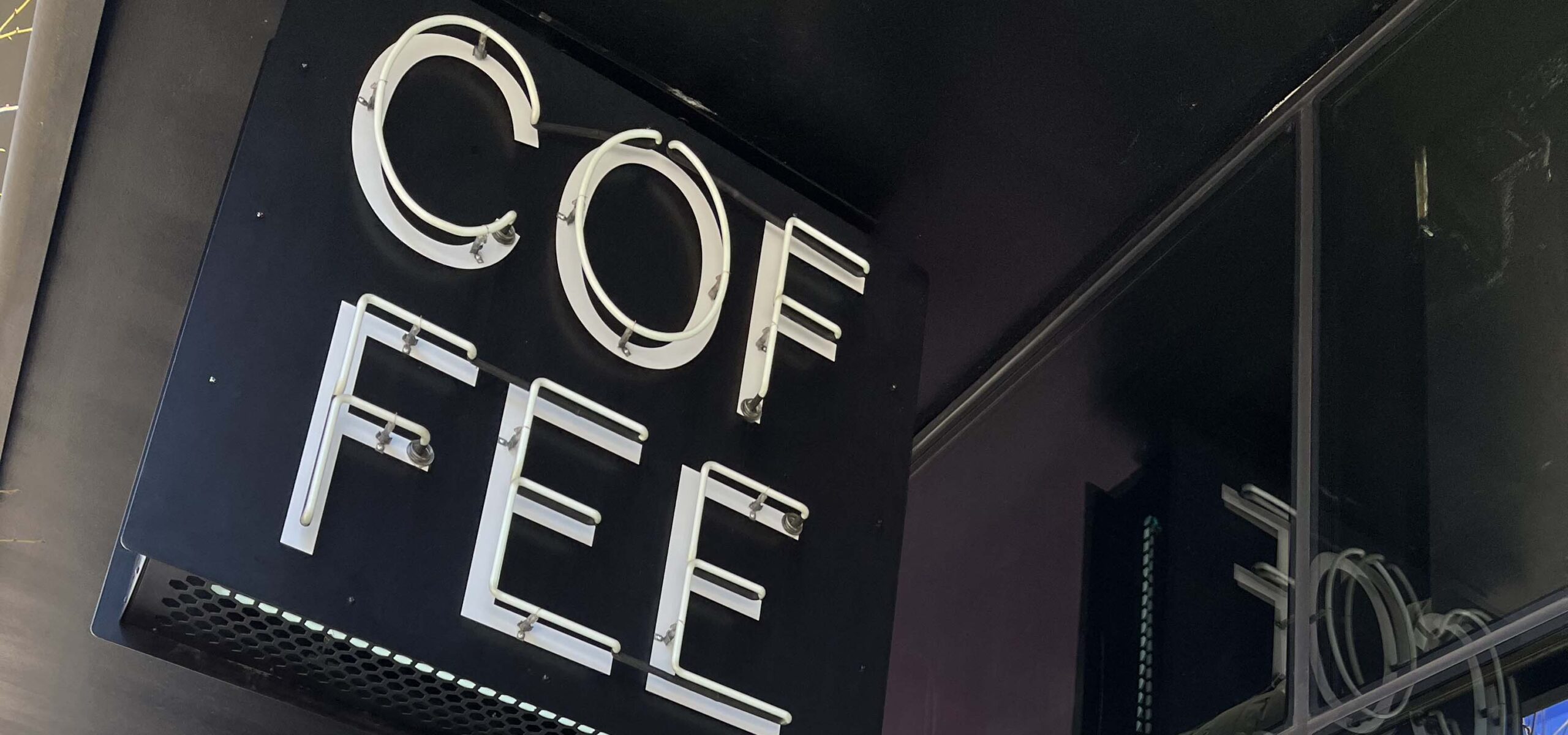 A coffee shop overhead marquee sign.