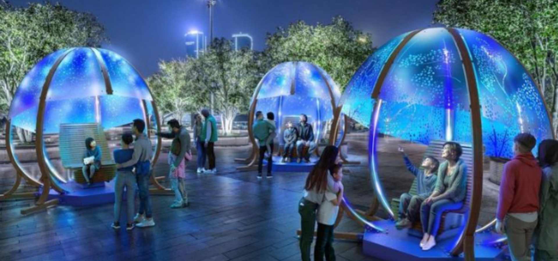 People sitting is domed seats on a plaza.