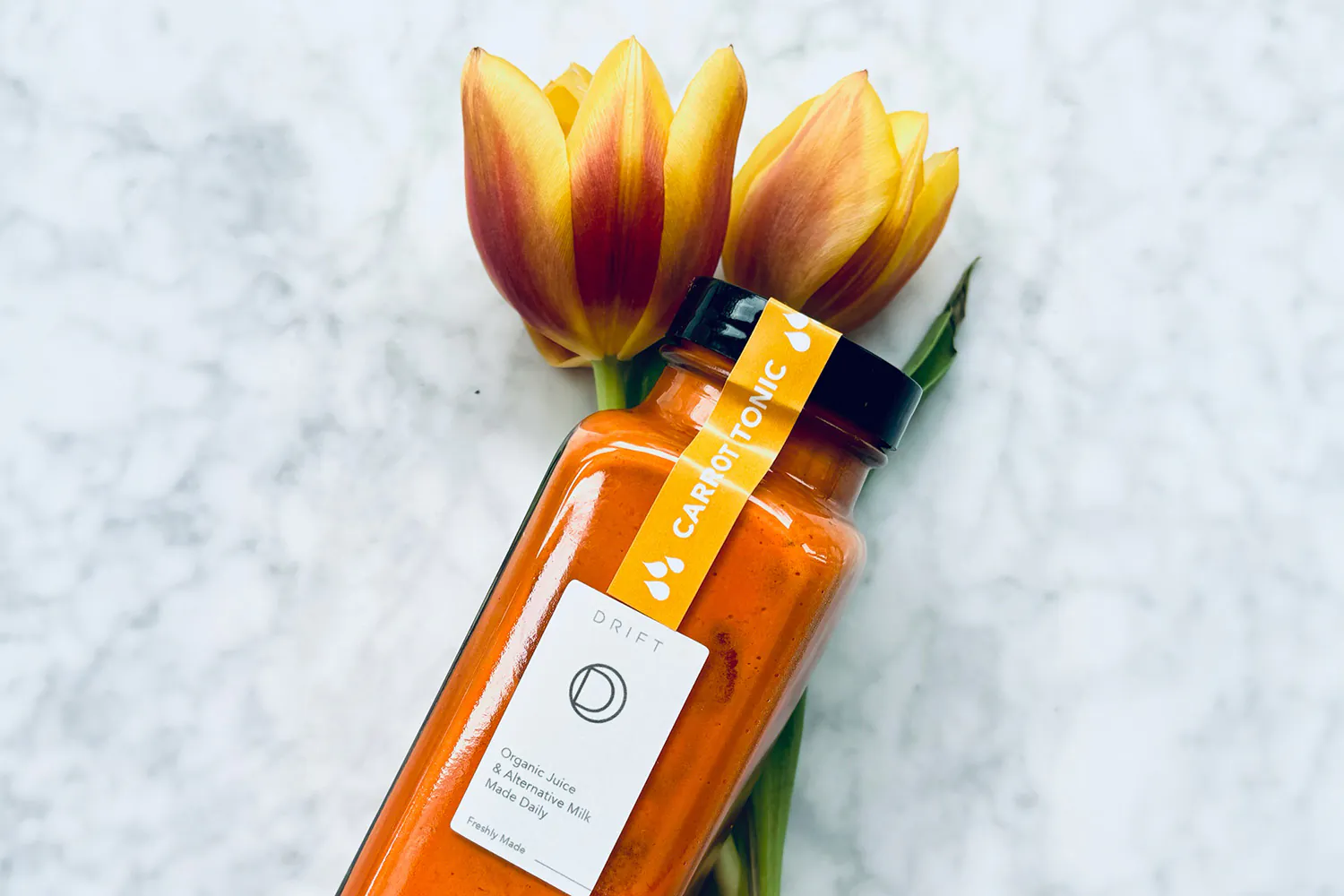 bottle of juice and tulips