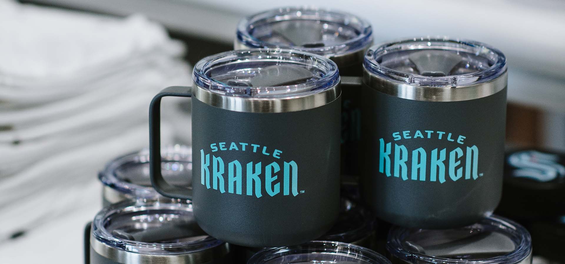 Seattle Kraken merchandise table with mugs on it