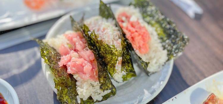 Plate of open faced sushi rolls.