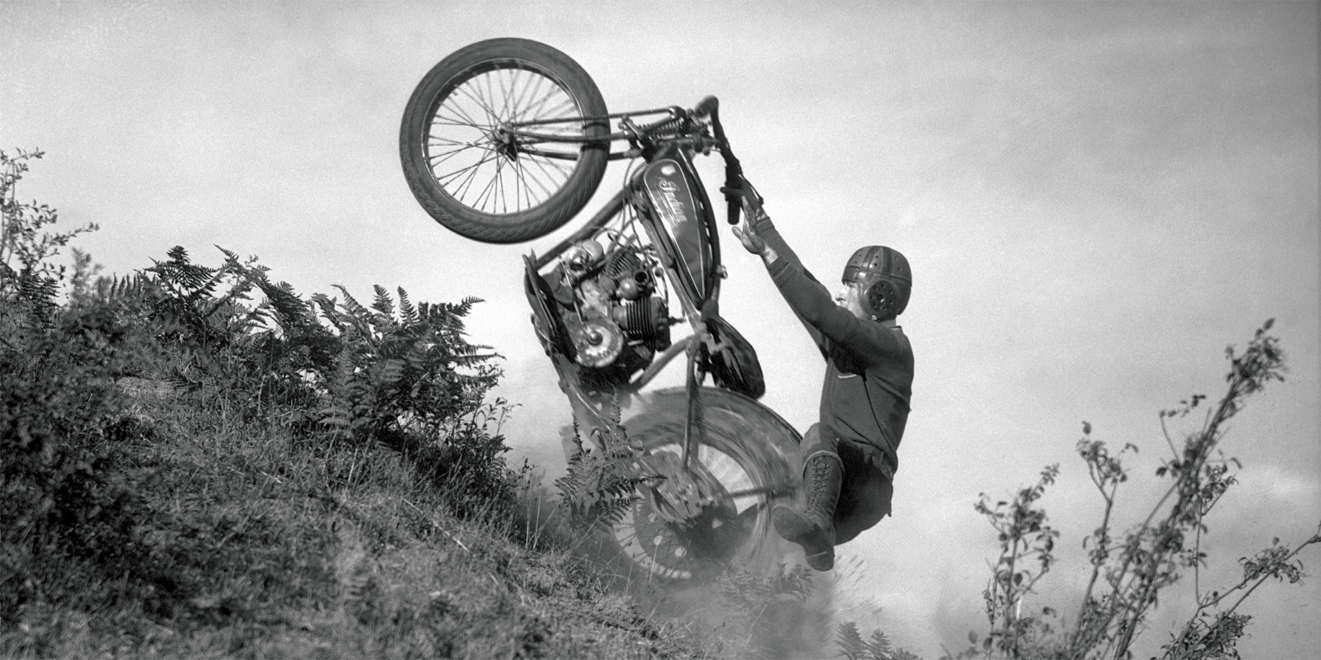 historical image of man on motorcycle