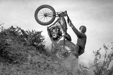 historical image of man on motorcycle