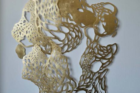 Laser cut brass metal abstract art wall-hanging.