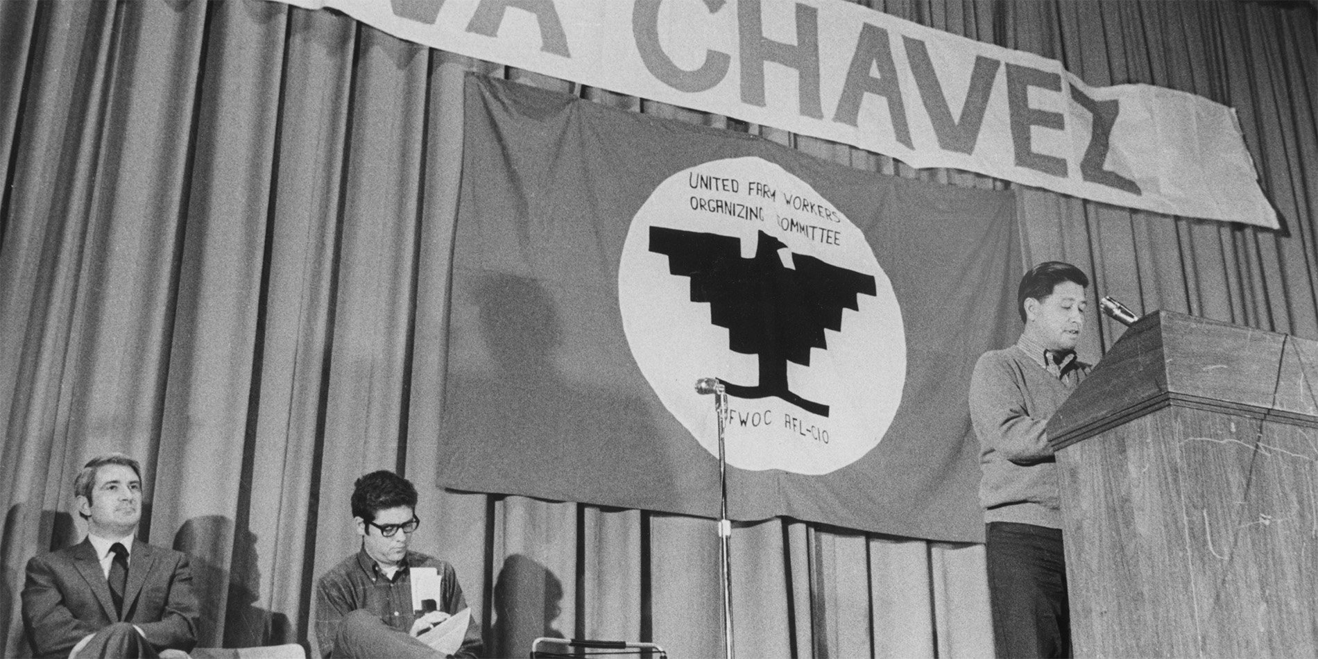 old photograph of person speaking at event