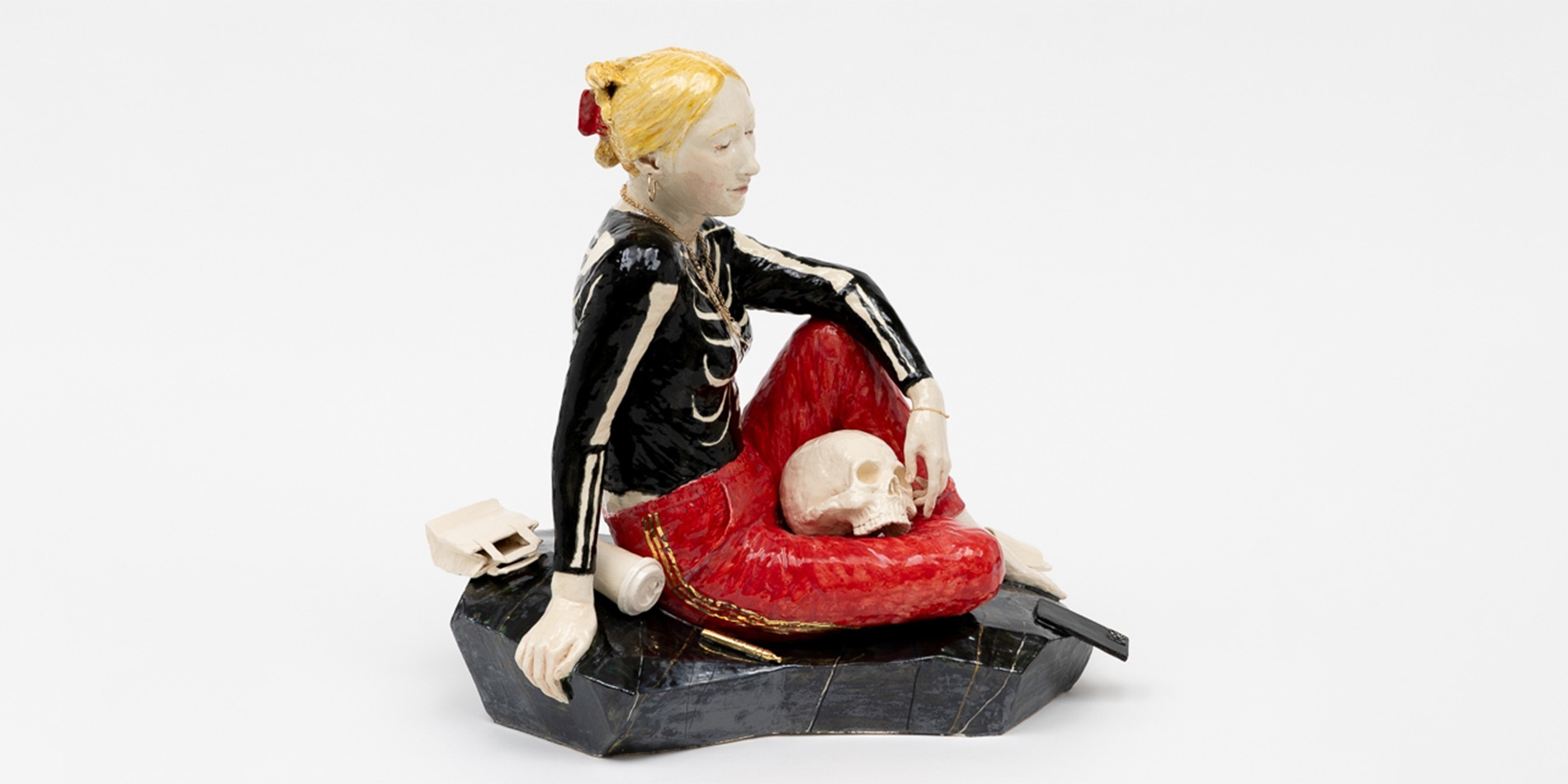 sculpture of sitting woman with skull