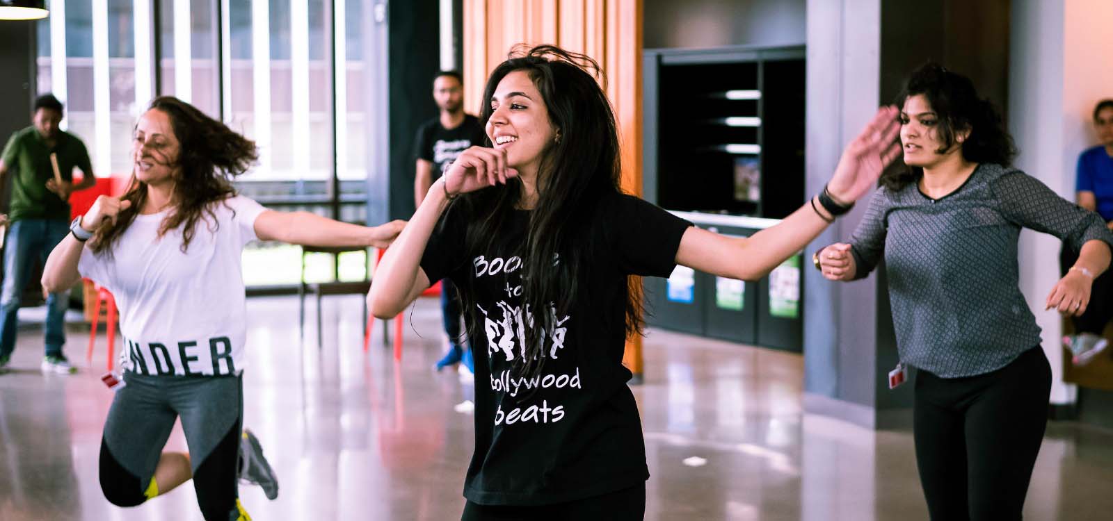 3 women dancing in a class.