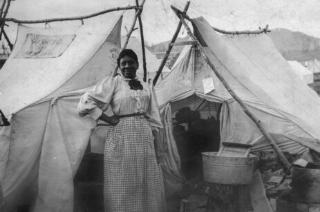 Woman posing in front of a tent.