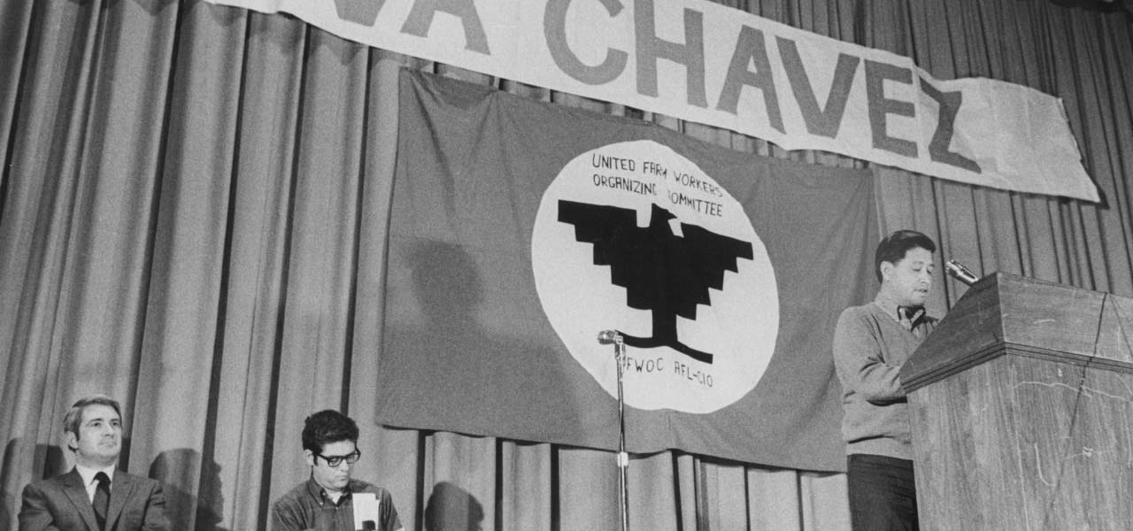 Cesar Chavez speaking at a podium.