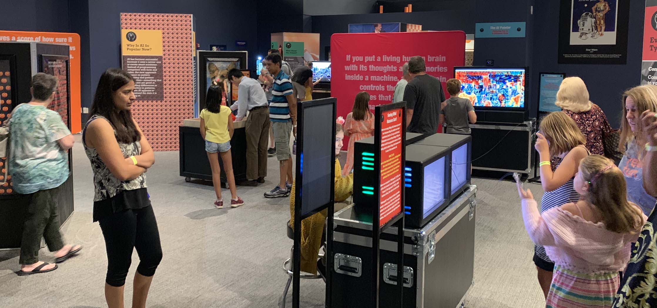 People looking at an exhibit in a museum.