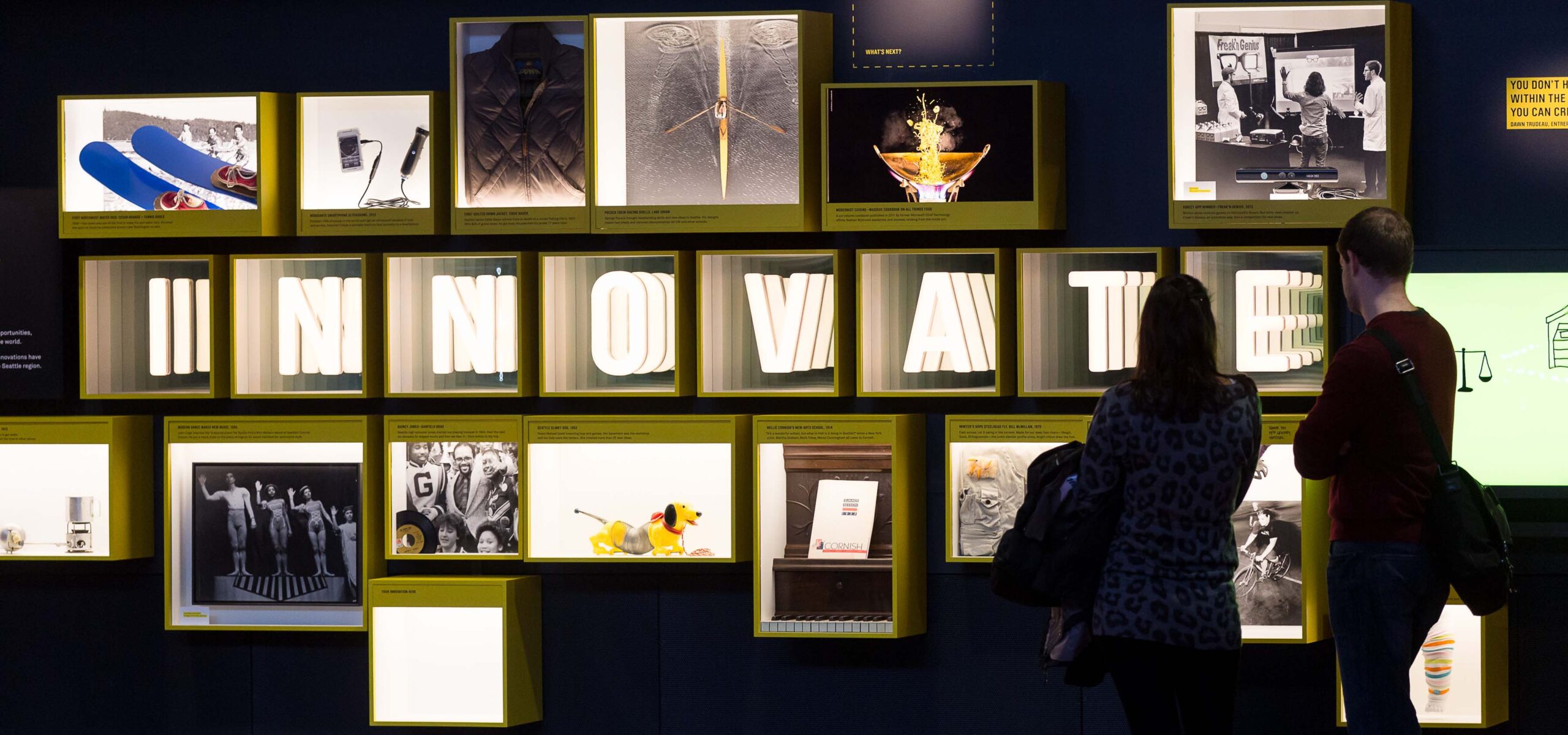 Patrons viewing an exhibit at a museum.