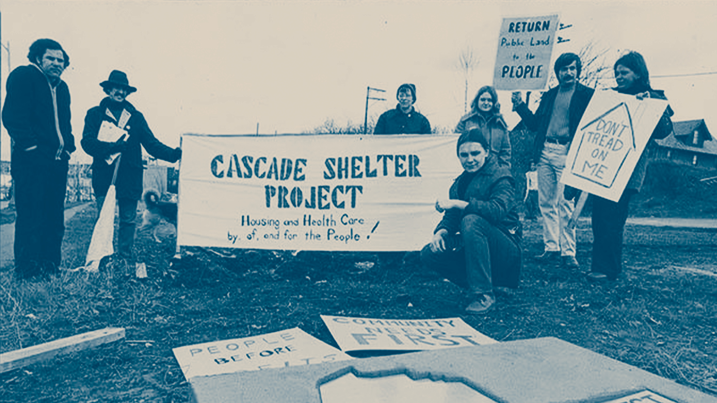 Black and white old photo of SLU community protestors with signs.