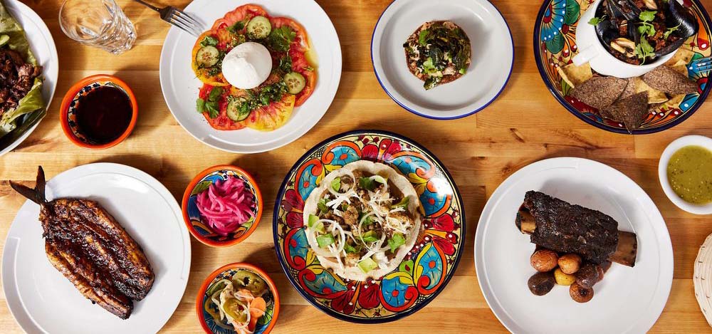 Table spread of Mexican dishes and foods.