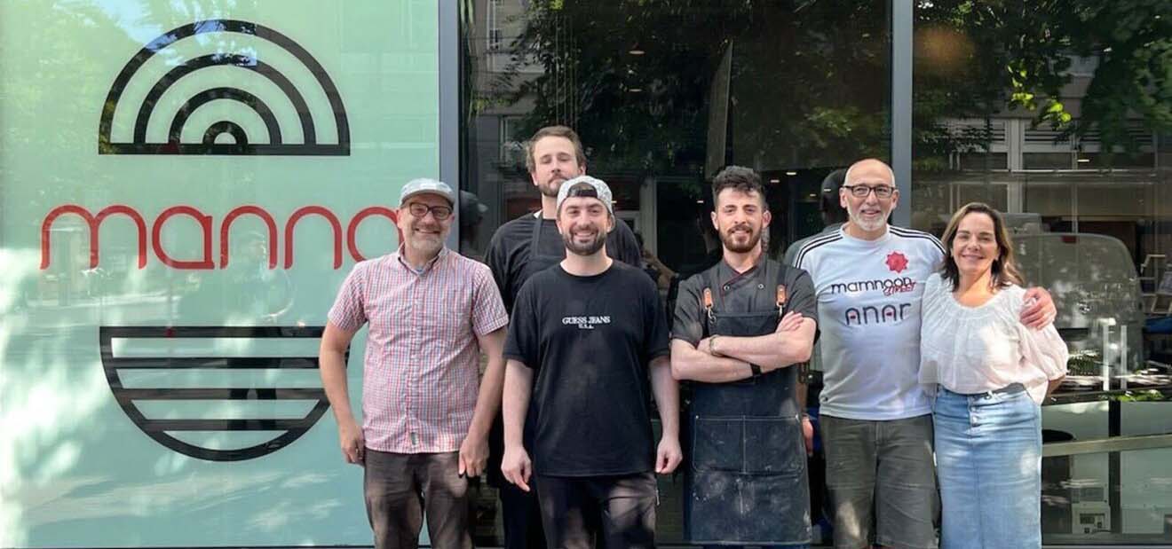 Family standing in front of a restaurant.