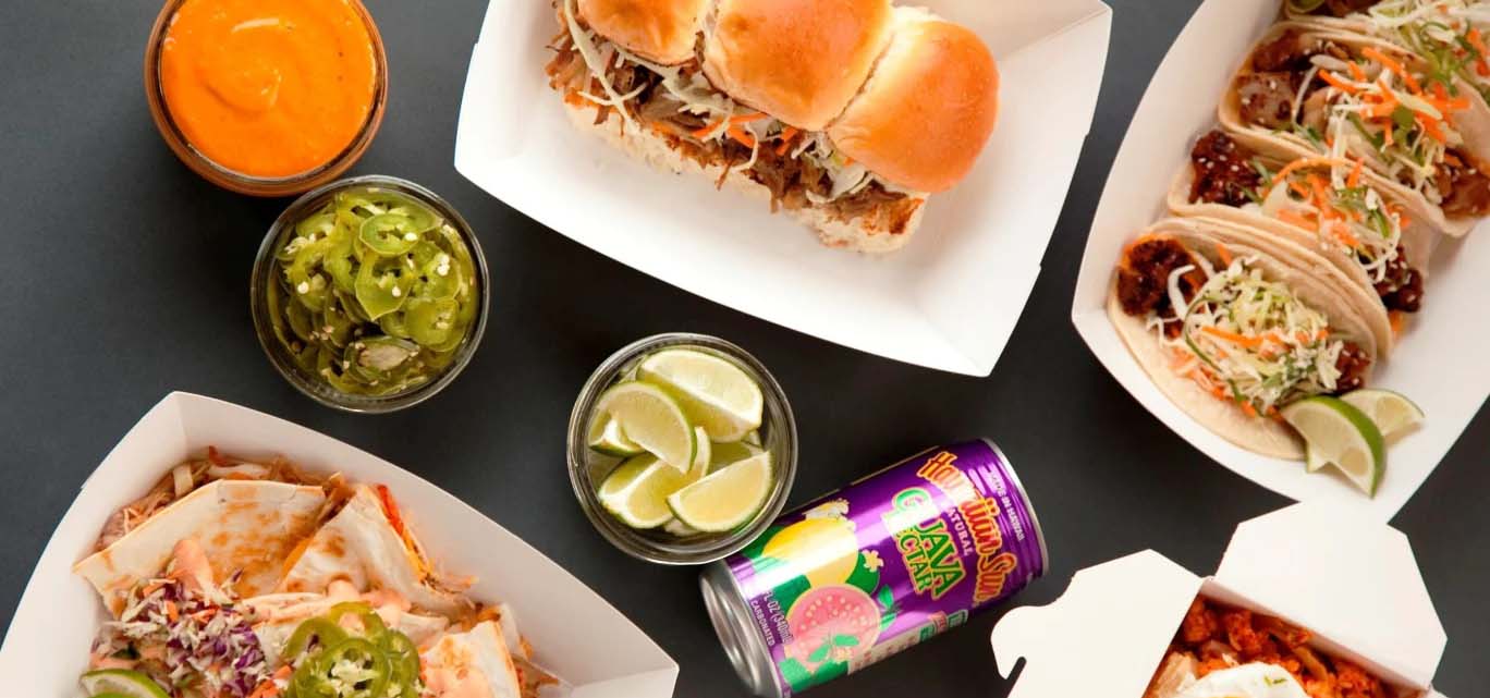 Birds-eye view of Marination dishes like sliders and tacos.