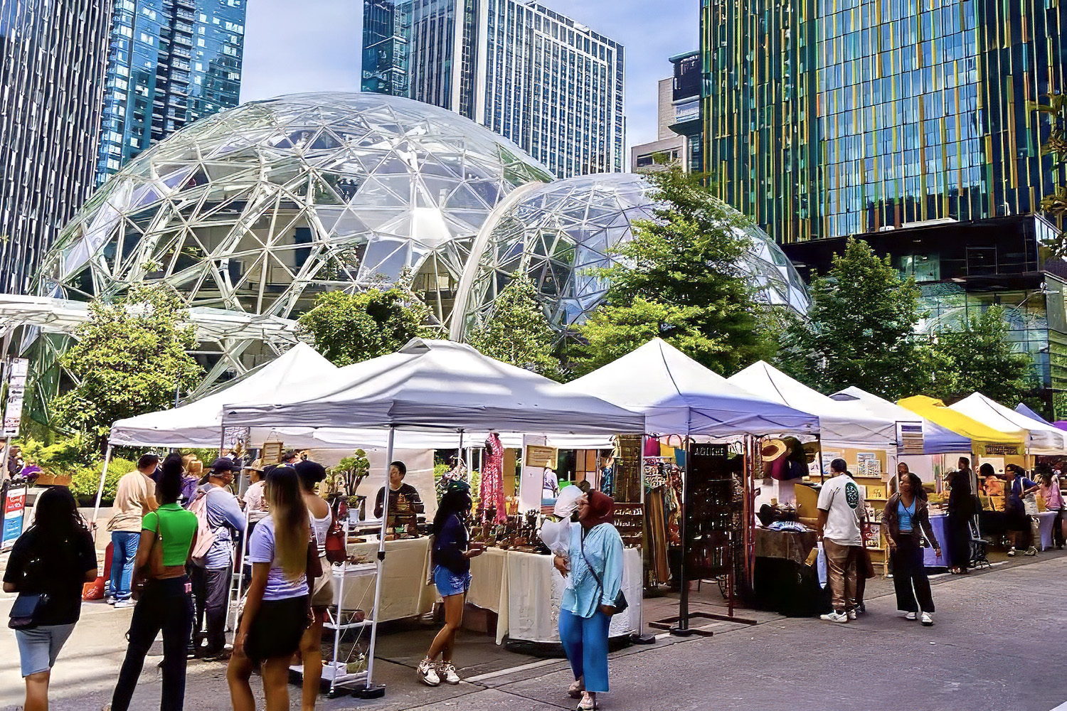 people shopping at farmers market by the spheres