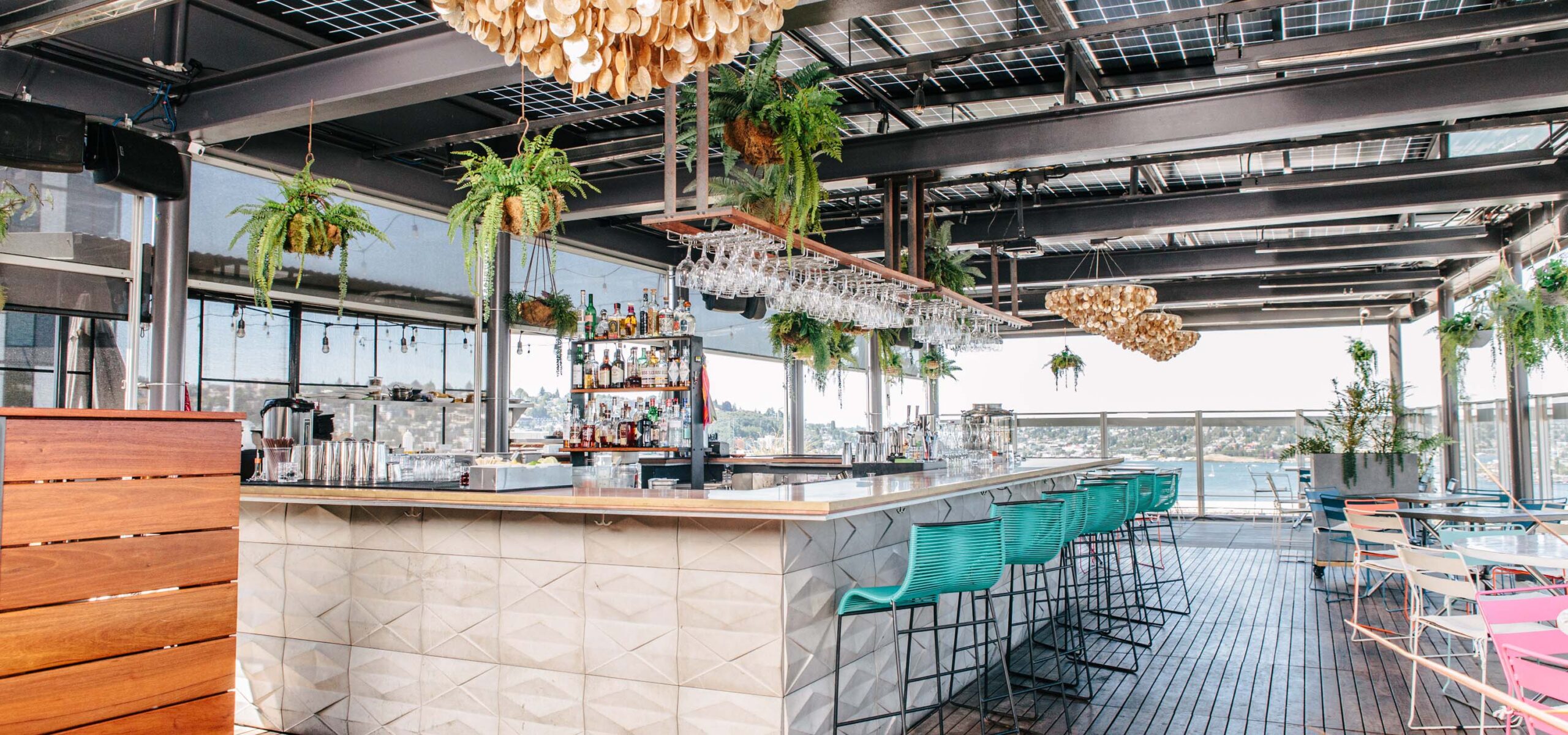 Swank indoor/outdoor patio bar with blue chairs.