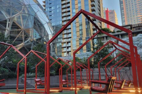 Interactive swings inside red frames that look like houses.