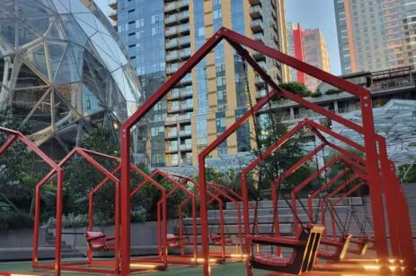 Interactive swings inside red frames that look like houses.