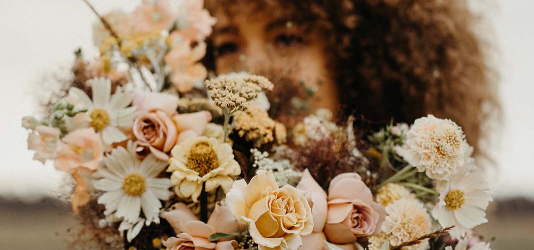 Woman holding flower bouquet.