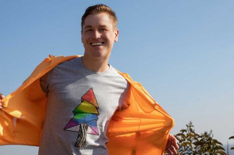 person wearing rainbow tree shirt