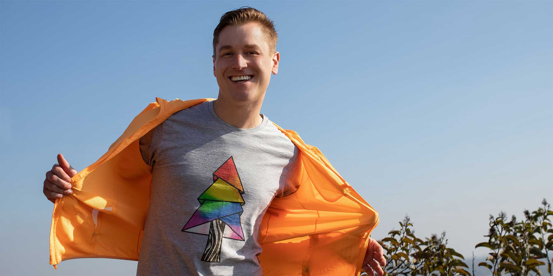 person wearing rainbow tree shirt