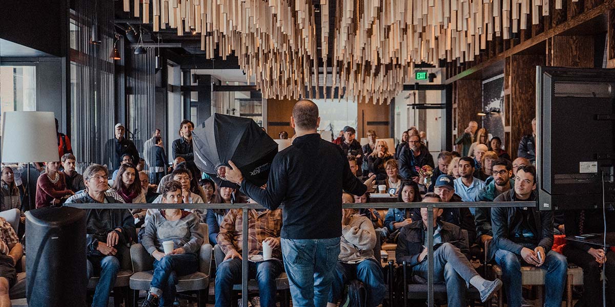 man speaking in front of crowd