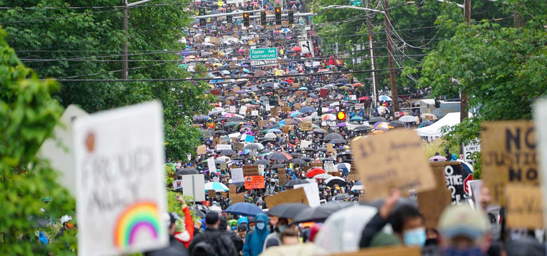 Down-street view of a protest with thousands of attendees