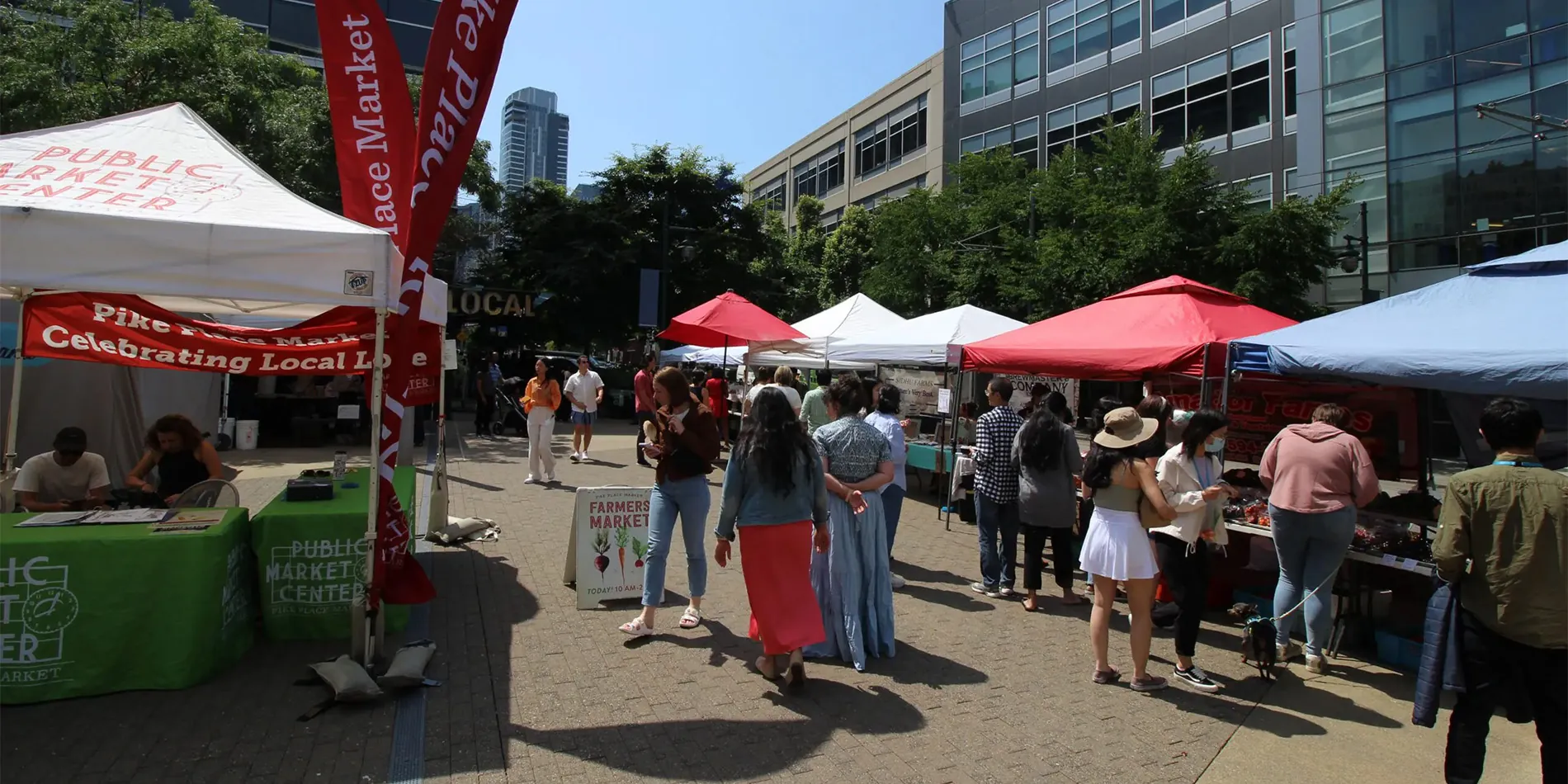 people shopping at outdoor farmers market