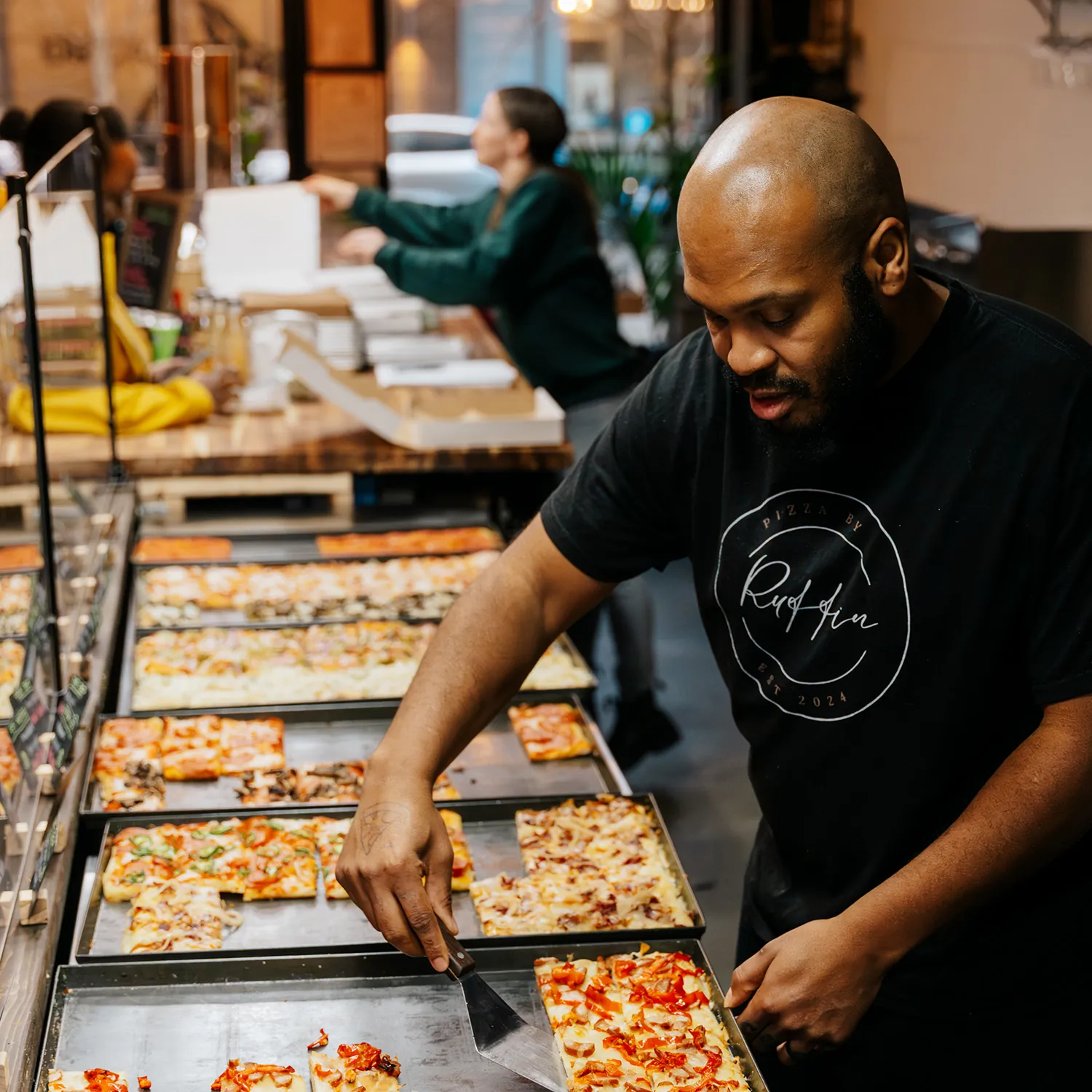 isaiah serving pizza