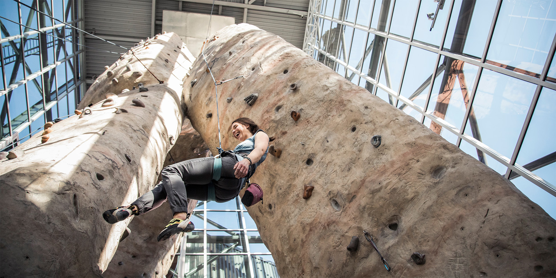 woman climbing rock wall