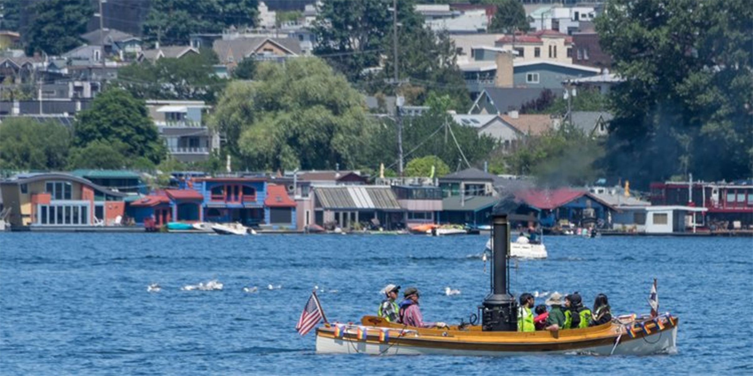 people in boat on lake union