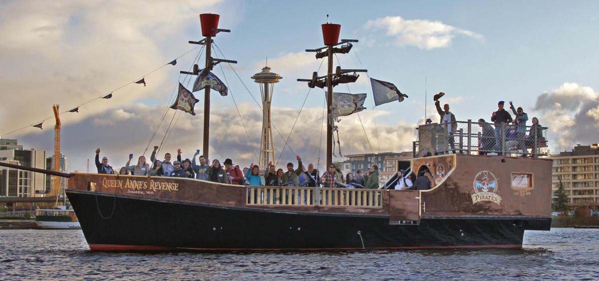 People waving from a pirate ship cruise.