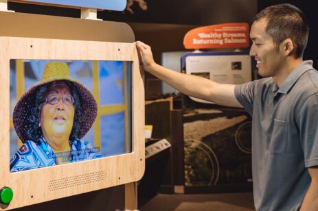 Man looking at a video exhibit.