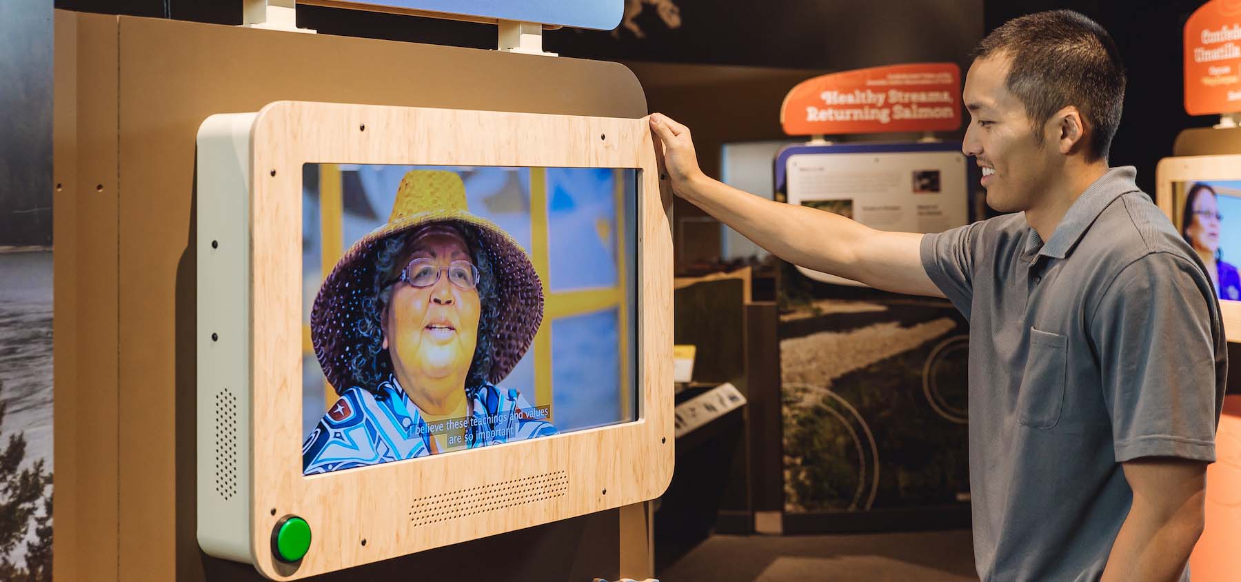Man looking at a video exhibit.
