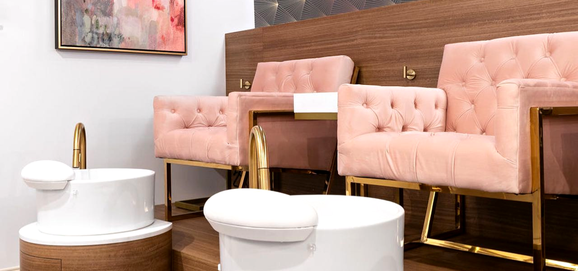Inside a nail salon with pink chairs.